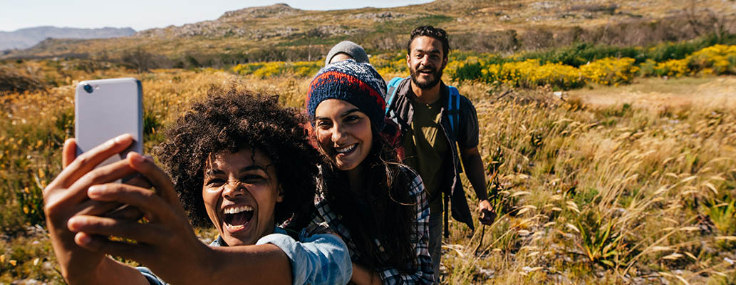 Young people outside taking a selfie on their mobile phone