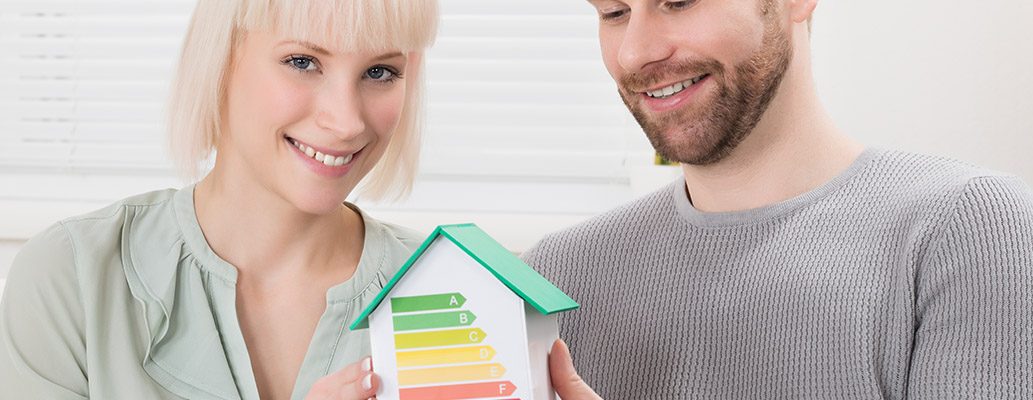 A couple holding an energy efficient house