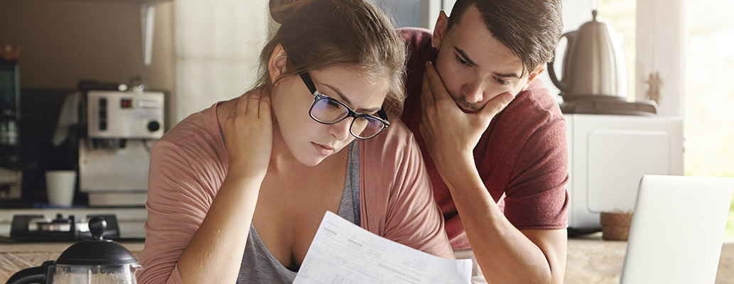 A couple studying forms and papers