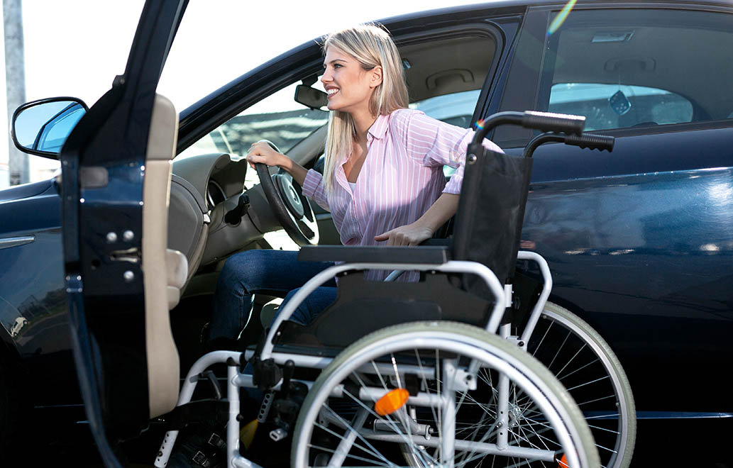 A disabled woman getting out a car