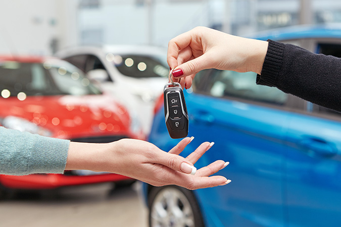 handing over keys to a new car