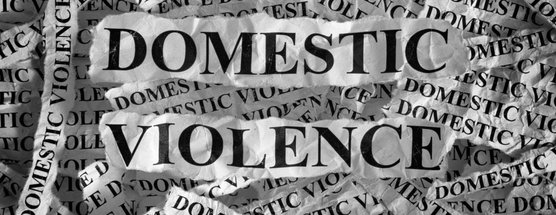 A banner with newspaper letters making up the words Domestic Violence