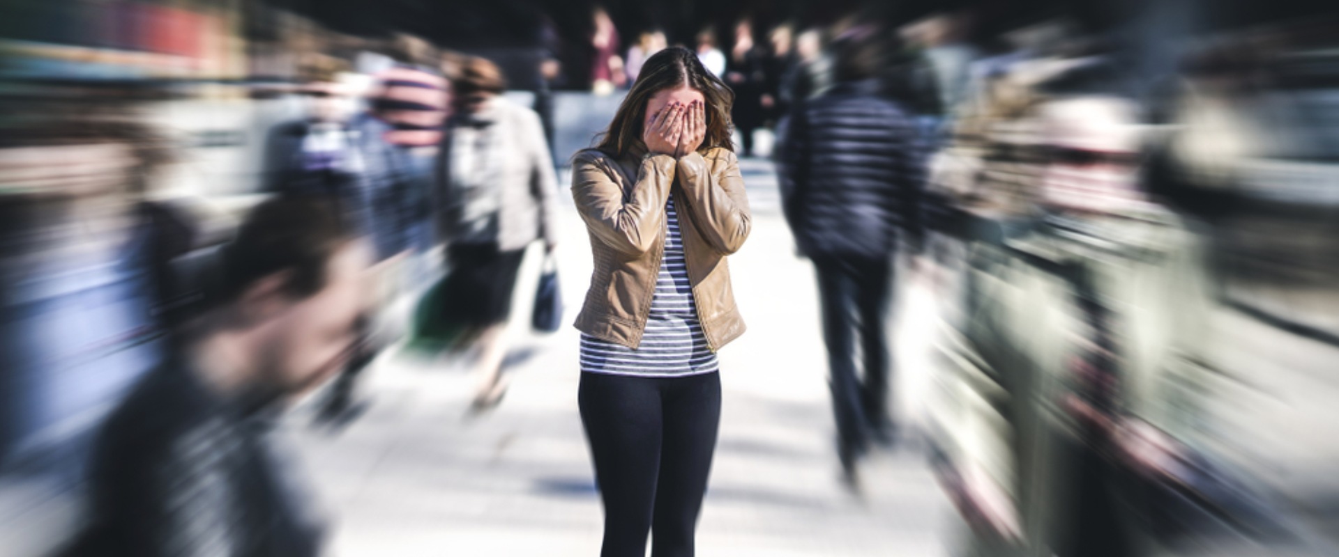 A girl struggling with anxiety in a crowd