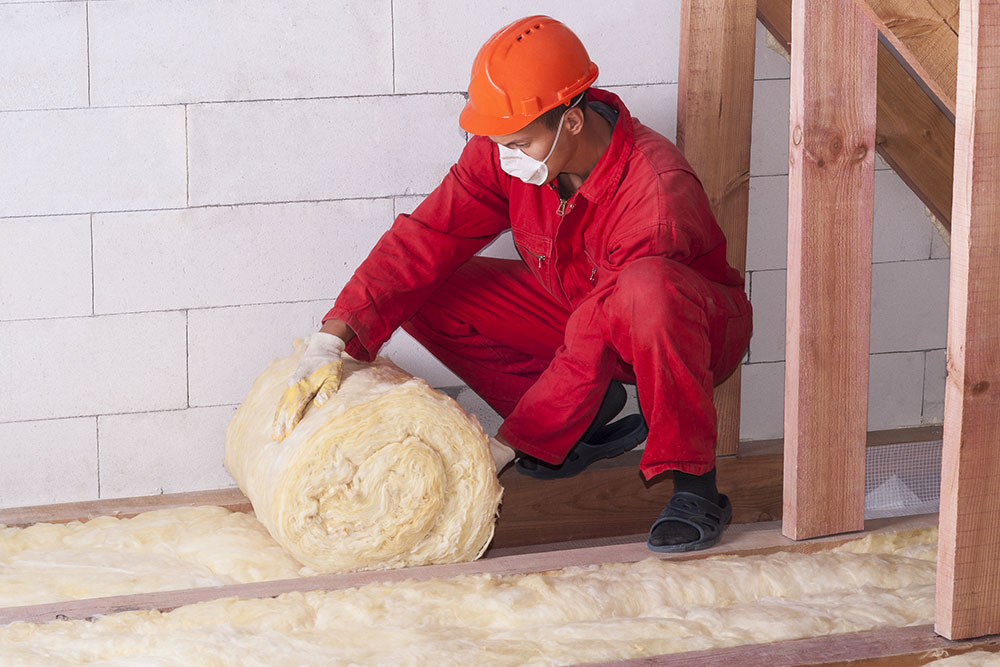 A worker fitting home insulation
