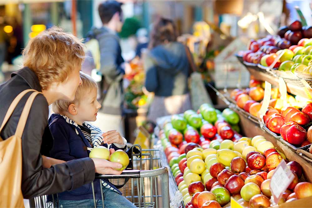 A woman and child fruit shopping in a store