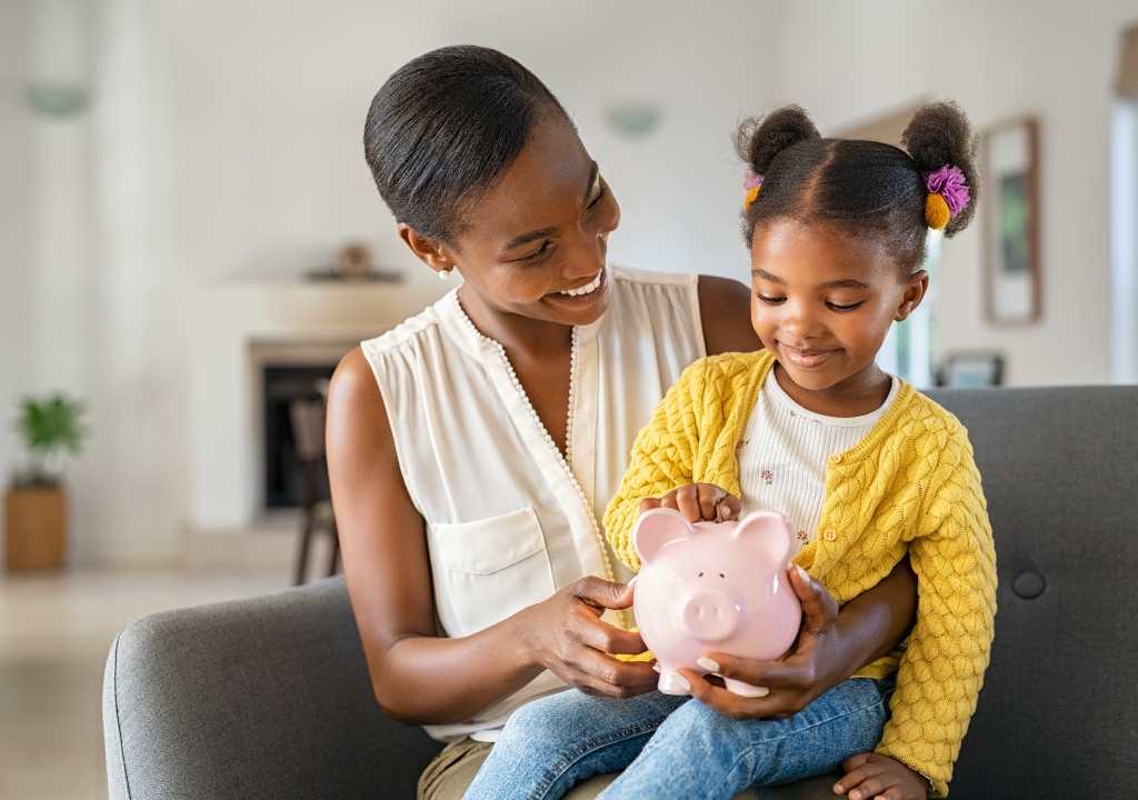 Mother and daughter with piggy bank