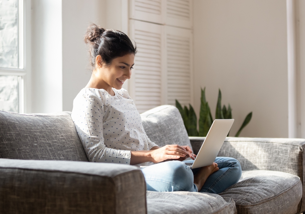 Girl on sofa looking online