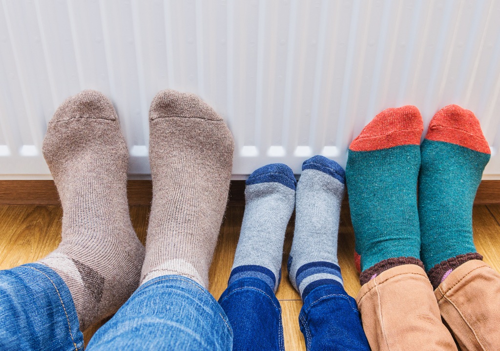 Feet with socks by radiator