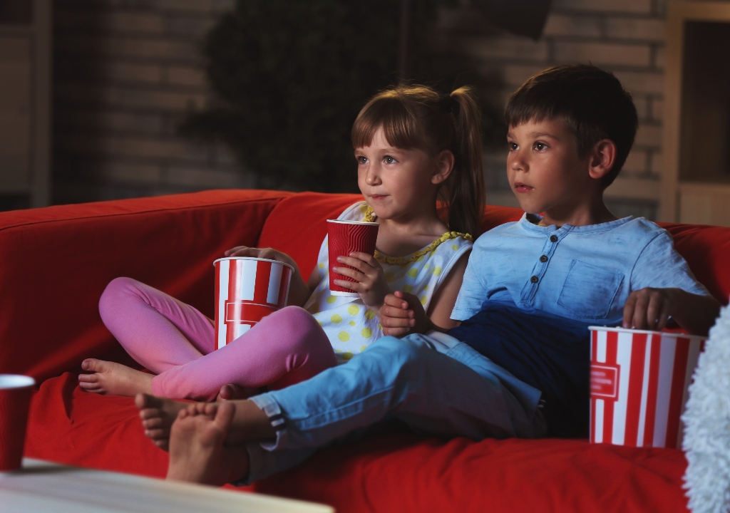 Kids watching a movie with popcorn