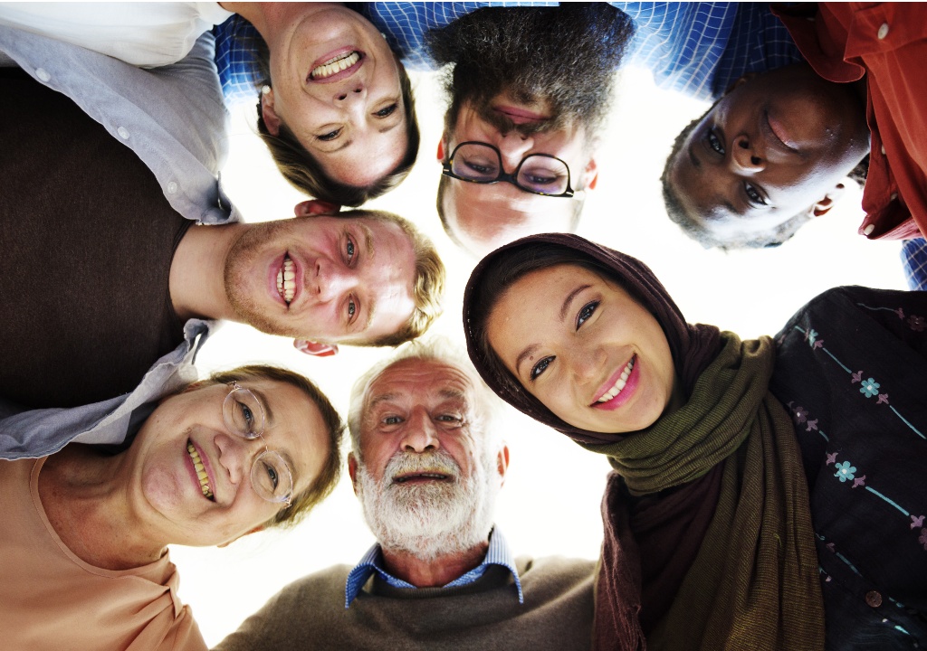 Diverse group of people in a circle looking at the camera