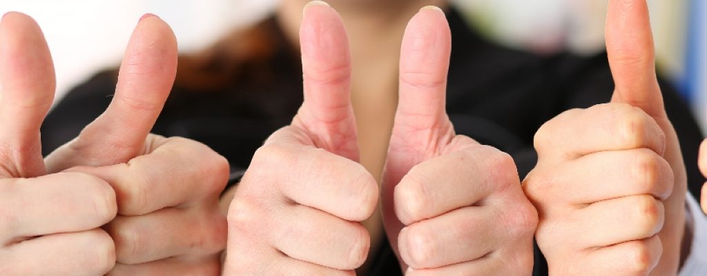 Photos of group of people with their thumbs up