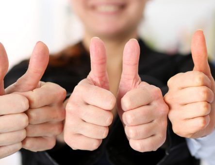Photos of group of people with their thumbs up