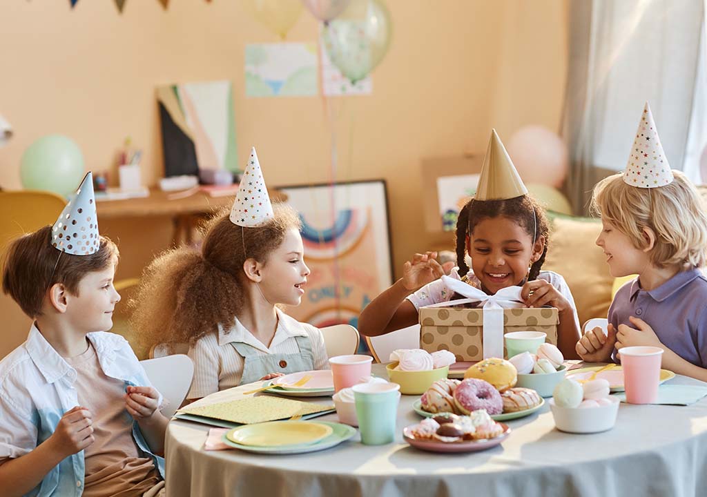 Kids having a birthday party indoors.