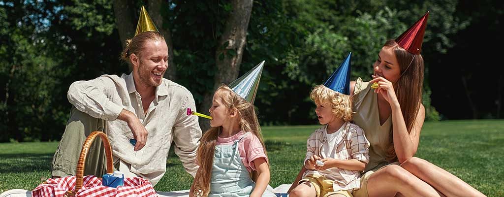 A family celebrating a party outdoors.