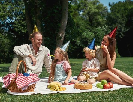 A family celebrating a party outdoors.