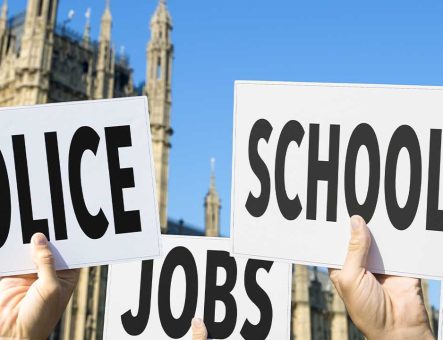 Placards read police, jobs and school being help outside Westminster.