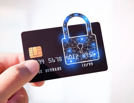 A credit card with a digital lock on it being held by a person.